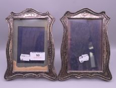 A pair of silver photograph frames. 18.5 cm high.