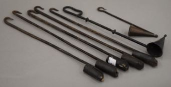 A collection of wrought iron candle hangers and snuffers.