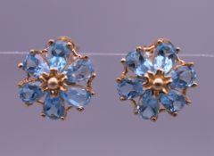 A pair of 9 ct gold topaz daisy cluster earrings. 1 cm wide. 2 grammes total weight.
