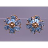 A pair of 9 ct gold topaz daisy cluster earrings. 1 cm wide. 2 grammes total weight.