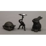 A monkey form candlestick, a model of a tortoise and a model of a rabbit. The former 10 cm high.