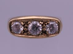 A 9 ct gold gentleman's three stone diamond ring. Ring size R/S. 5.1 grammes total weight.