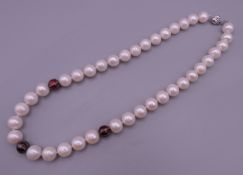 A pearl and diamond necklace with an 18 ct white gold clasp. 46 cm long.