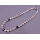 A pearl and diamond necklace with an 18 ct white gold clasp. 46 cm long.