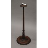 A late 19th/early 20th century turned wooden wig stand. 38.5 cm high.