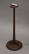 A late 19th/early 20th century turned wooden wig stand. 38.5 cm high.