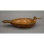 A 19th century Scandinavian chip carved wooden bowl of duck form, impressed flagon mark to base. 33.
