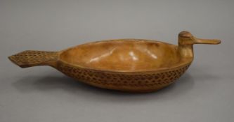 A 19th century Scandinavian chip carved wooden bowl of duck form, impressed flagon mark to base. 33.