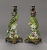 A pair of metal mounted porcelain parrot form candlesticks. 35 cm high.