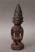 An African Yoruba tribal carved wooden figure. 27.5 cm high.