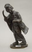 A Japanese Meiji period patinated bronze model of a geisha,