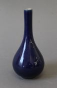 A Chinese blue porcelain straight neck vase. 14.5 cm high.