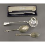 A cased cake knife, a plated ladle and plated salad servers.