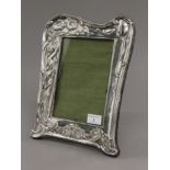 An Art Nouveau silver photograph frame. 32 cm high.