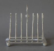 A silver plated golf club toast rack.