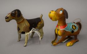 Two vintage tinplate clockwork dogs, one DRGM and the other Made in China. The former 13 cm long.