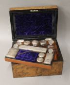A Victorian fitted walnut travelling box, the fitments with silver plate mounts.
