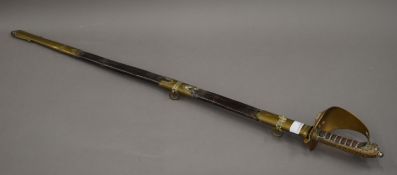 A Naval dress sword in scabbard. 97.5 cm long.