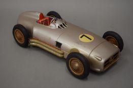 A vintage tinplate racing car. 32 cm long.