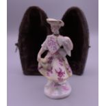 A 19th century Continental porcelain snuff bottle in the form of a lady holding a fan,