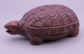 A wooden box in the form of a tortoise. 12 cm long.