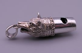A silver whistle in the form of a fox's head. 3.5 cm long excluding suspension loop.