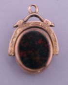 A Victorian 10 ct gold swivel fob. 2.5 cm high including suspension loop. 4.1 grammes total weight.