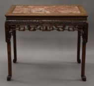A 19th century Chinese carved hardwood rouge topped table. 91 x 55 cm, 81 cm high.