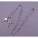 Two silver crosses on a silver chain. Chain 56 cm long, largest cross 3.5 cm high. 10.5 grammes.