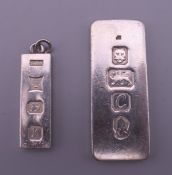 Two silver ingots. 4 cm and 2.75 cm high respectively. 26.4 grammes.