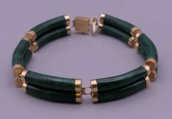 A 14 K gold and malachite bracelet. 17.5 cm long.