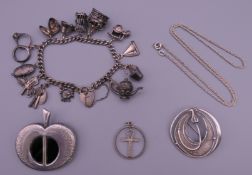 A charm bracelet, a silver brooch in the form of an apple, a silver Art Nouveau style brooch,