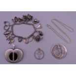 A charm bracelet, a silver brooch in the form of an apple, a silver Art Nouveau style brooch,
