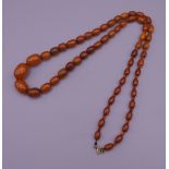 An amber necklace. Approximately 76 cm long.