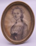 A 19th century pencil portrait miniature of a young lady, framed and glazed. 6.5 cm high overall.