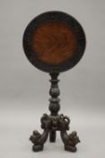 A 19th century Eastern carved tilt top tripod table. 45.5 cm diameter.