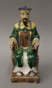 A Chinese Sanci seated figure. 22 cm high.