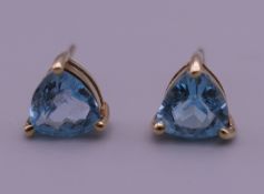 A pair of 9 ct gold and trapeze cut blue tourmaline earrings. 7 mm high.