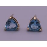 A pair of 9 ct gold and trapeze cut blue tourmaline earrings. 7 mm high.