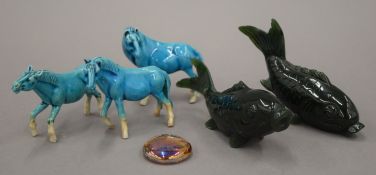 Two Chinese carved fish and three turquoise porcelain horses. The former each 10.5 cm long.