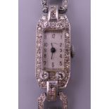 An Art Deco platinum diamond set ladies cocktail watch. 1.25 cm wide. 20.