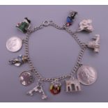 A silver charm bracelet with eleven charms. Bracelet 18 cm long. 30.3 grammes.