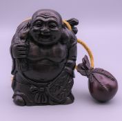 An inro in the form of Buddha. 8.5 cm high.
