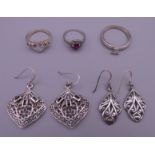 Three silver rings and two pairs of silver earrings. Largest earrings 3 cm x 2.75 cm. 18.