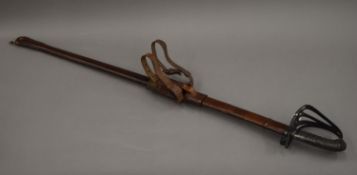 A Victorian dress sword in leather scabbard. 98 cm long.