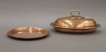 An Arts and Crafts beaten copper dish and an entree dish. The former 22 cm diameter.
