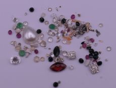 A bag of assorted gemstones to include diamonds, sapphires, emeralds, etc.