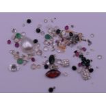 A bag of assorted gemstones to include diamonds, sapphires, emeralds, etc.