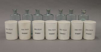 Seven ceramic jars from Leach F.R.C.V.S Newmarket and seven bottles.