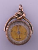 A rose gold compass/pendant fob. Compass 2 cm diameter. 10.6 grammes total weight.